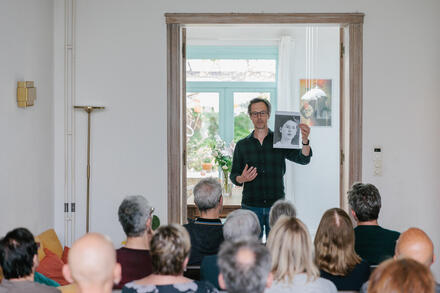 man toont foto aan publiek